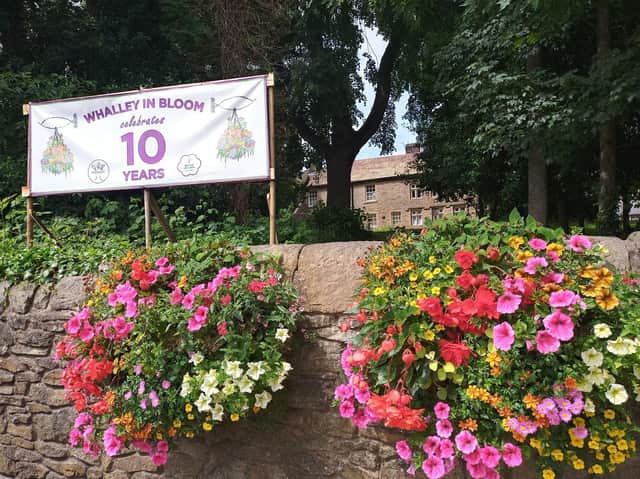 Wall-mounted floral planter as the village prepares to enter this year's contest
