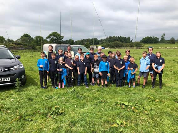 Armed with their fishing rods, pupils get ready to fish