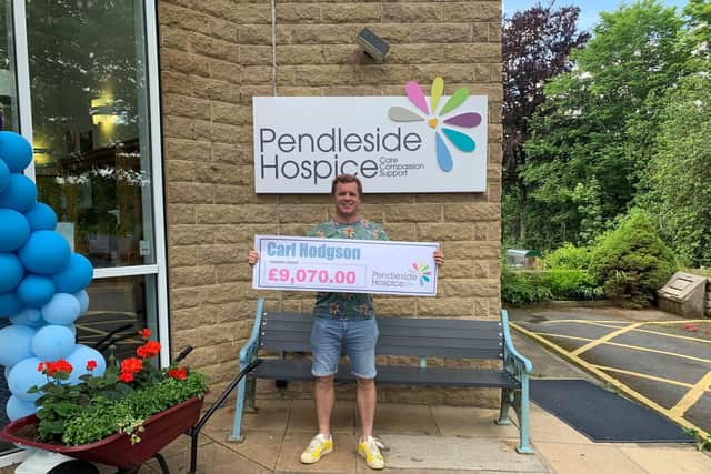Carl Hodgson with a cheque for the latest amount of money he has raised for Pendleside Hospice