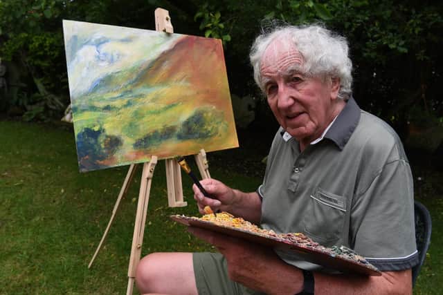 Michael Hipkins pictured at work on a painting  Photo: Neil Cross