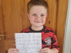 Alfie with the letter he has written to Marcus Rashford and his team mates