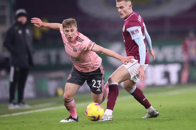 Ben Osborn of Sheffield United is challenged by Josh Benson of Burnley during the Premier League match between Burnley and Sheffield United at Turf Moor on December 29, 2020 in Burnley, England.