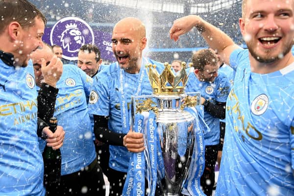 Pep Guardiola, Manager of Manchester City celebrates with the Premier League Trophy as Manchester City are presented with the Trophy as they win the league following the Premier League match between Manchester City and Everton at Etihad Stadium on May 23, 2021 in Manchester, England.