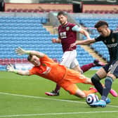 Rodrigo Moreno of Leeds United scores their side's fourth goal past Bailey Peacock-Farrell of Burnley during the Premier League match between Burnley and Leeds United at Turf Moor on May 15, 2021 in Burnley, England.