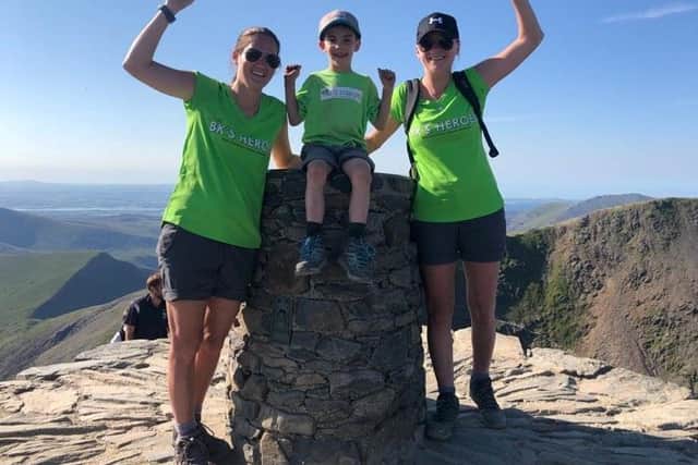 We did it! Cole Shaw at the top of Snowdon with his aunt Sarah Darcy (left) and her partner Danielle Nuttall