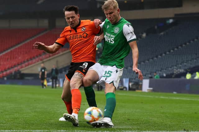 Josh Doig of Hibernian FC makes a cross whilst under pressure from Marc McNulty of Dundee United during the William Hill Scottish Cup match between Dundee United and Hibernian at Hampden Park on May 08, 2021 in Glasgow, Scotland.