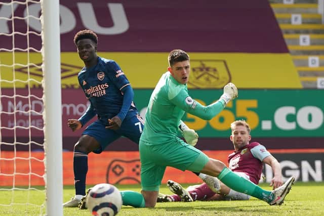 Bukayo Saka of Arsenal shoots past Nick Pope of Burnley during the Premier League match between Burnley and Arsenal at Turf Moor on March 06, 2021 in Burnley, England.