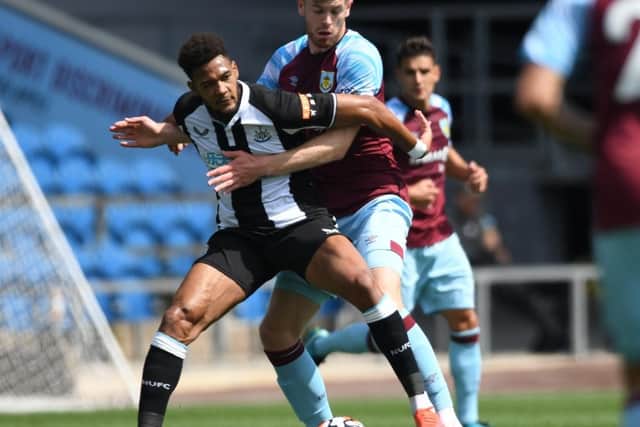 Nathan Collins sticks tight to Joelinton during the pre-season friendly between Burnley and Newcastle United at Turf Moor.