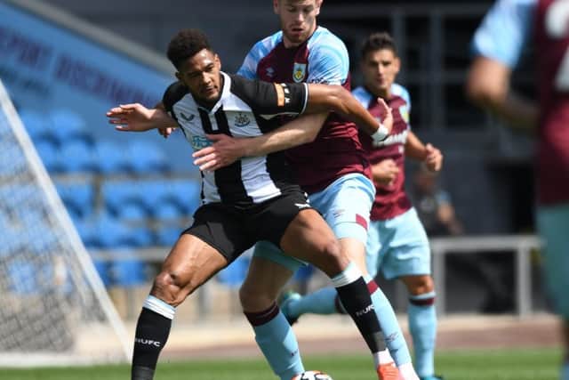 Burnley's Nathan Collins refuses to give Newcastle United's Joelinton any room to manoeuvre during a pre-season game at Turf Moor.