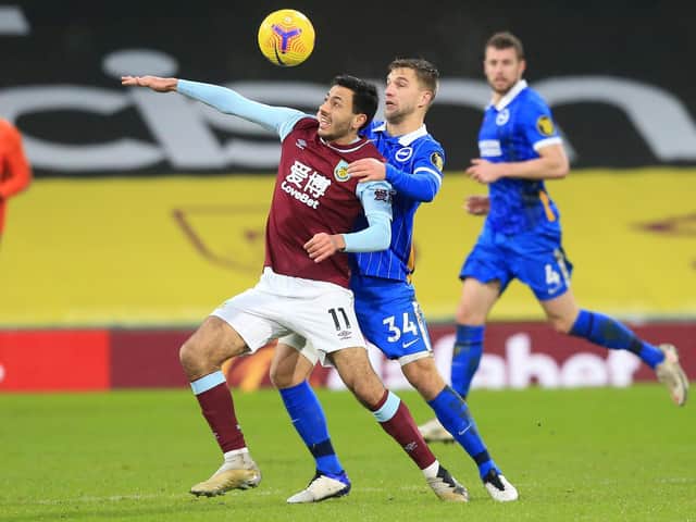 Dwight McNeil of Burnley battles for possession with Joel Veltman of Brighton & Hove Albion during the Premier League match between Burnley and Brighton & Hove Albion at Turf Moor on February 06, 2021 in Burnley, England.