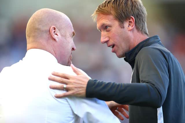 Graham Potter, Manager of Brighton and Hove Albion greets Sean Dyche, Manager of Burnley prior to the Premier League match between Brighton & Hove Albion and Burnley FC at American Express Community Stadium on September 14, 2019 in Brighton, United Kingdom.
