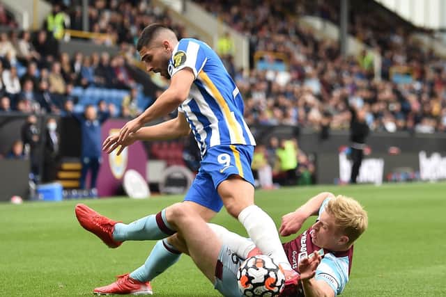 Neal Maupay of Brighton and Hove Albion is challenged by Ben Mee of Burnley during the Premier League match between Burnley and Brighton & Hove Albion at Turf Moor on August 14, 2021 in Burnley, England.