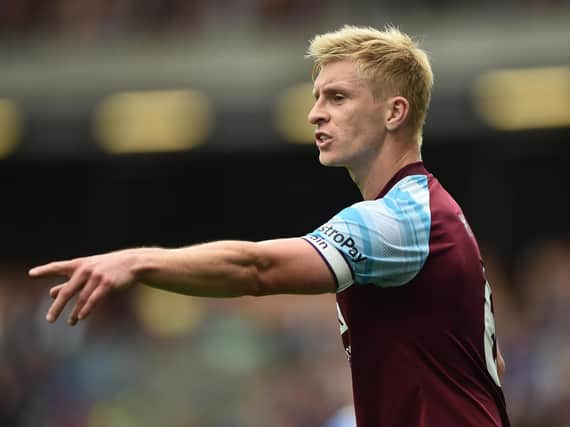 Ben Mee of Burnley gestures during the Premier League match between Burnley and Brighton & Hove Albion at Turf Moor on August 14, 2021 in Burnley, England.