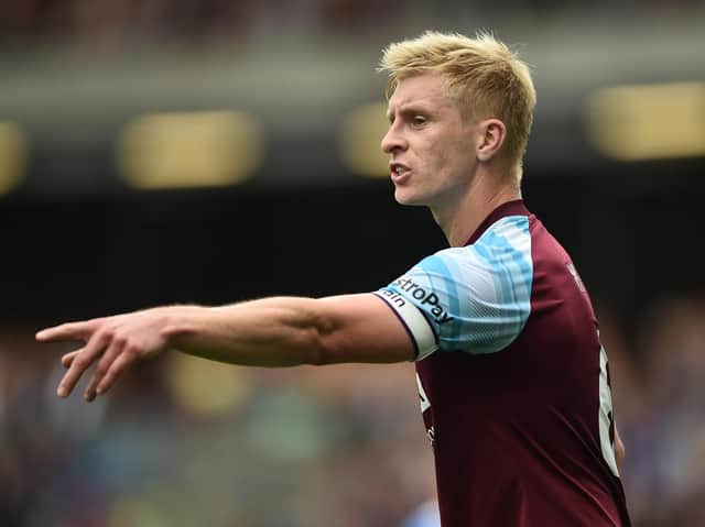 Ben Mee of Burnley gestures during the Premier League match between Burnley and Brighton & Hove Albion at Turf Moor on August 14, 2021 in Burnley, England.