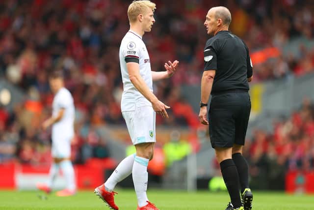 Ben Mee with referee Mike Dean