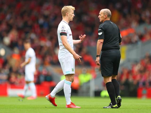 Ben Mee with referee Mike Dean