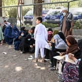 Internally displaced Afghan families, who fled from Kunduz and Takhar province due to battles between Taliban and Afghan security forces, eat their lunch at the Shahr-e-Naw Park in Kabul on 10th August, 2021