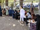 Internally displaced Afghan families, who fled from Kunduz and Takhar province due to battles between Taliban and Afghan security forces, eat their lunch at the Shahr-e-Naw Park in Kabul on 10th August, 2021