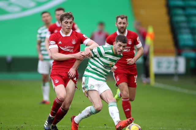 Dean Campbell of Aberdeen and Ryan Christie of Celtic battle for the ball during the Ladbrokes Scottish Premiership match between Celtic and Aberdeen at Celtic Park on February 27, 2021 in Glasgow, Scotland.