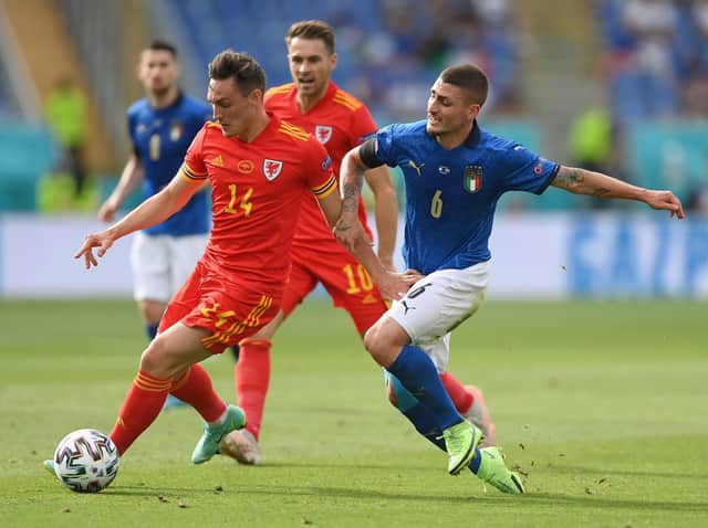 Connor Roberts of Wales battles for possession with Marco Verratti of Italy during the UEFA Euro 2020 Championship Group A match between Italy and Wales at Olimpico Stadium on June 20, 2021 in Rome, Italy.