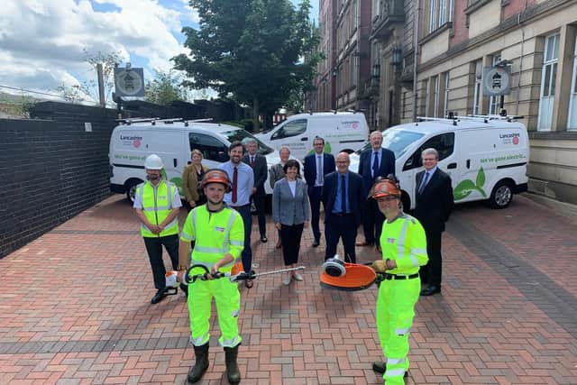 Lancashire County Council staff and cabinet members pictured outside County Hall with their new electric vans and maintenance equipment