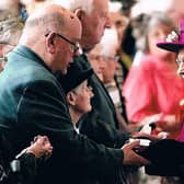 Canon Ron Greenall receiving Maundy money from HR Queen Elizabeth II at Blackburn Cathedral