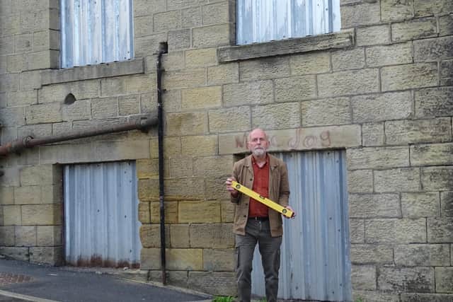 Campaigner Andy Shackleton in front of a derelict building in Colne