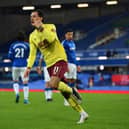 Dwight McNeil of Burnley celebrates after scoring their team's second goal during the Premier League match between Everton and Burnley at Goodison Park on March 13, 2021 in Liverpool, England.