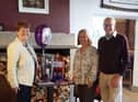 David Smith, who has stepped down as chairman of Burnley Twinning Association, and his wife Kay (left) receive their afternoon tea gift from vice chairman Janet Elliott.