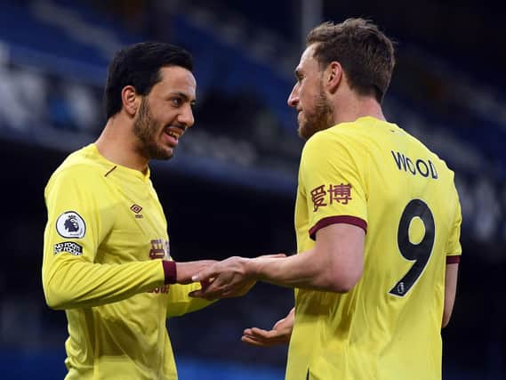 Burnley's English midfielder Dwight McNeil (L) and Burnley's New Zealand striker Chris Wood celebrate the second goal during the English Premier League football match between Everton and Burnley at Goodison Park in Liverpool, north west England on March 13, 2021.