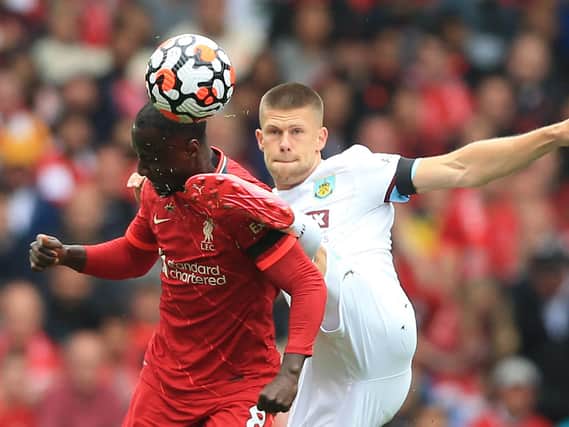 Liverpool's Guinean midfielder Naby Keita (L) vies with Burnley's Icelandic midfielder Johann Berg Gudmundsson during the English Premier League football match between Liverpool and Burnley at Anfield in Liverpool, north west England on August 21, 2021.