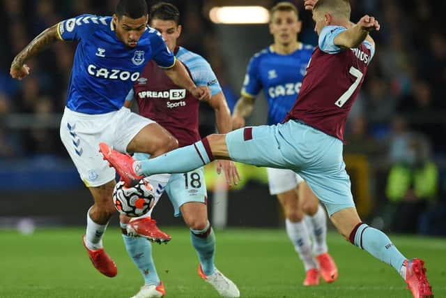 Everton's Brazilian midfielder Allan (L) vies with Burnley's Icelandic midfielder Johann Berg Gudmundsson (R) during the English Premier League football match between Everton and Burnley at Goodison Park in Liverpool, north west England on September 13, 2021.
