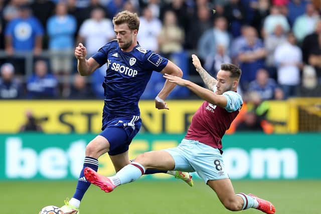 Patrick Bamford of Leeds United battles for possession with Josh Brownhill of Burnley during the Premier League match between Burnley and Leeds United at Turf Moor on August 29, 2021 in Burnley, England.