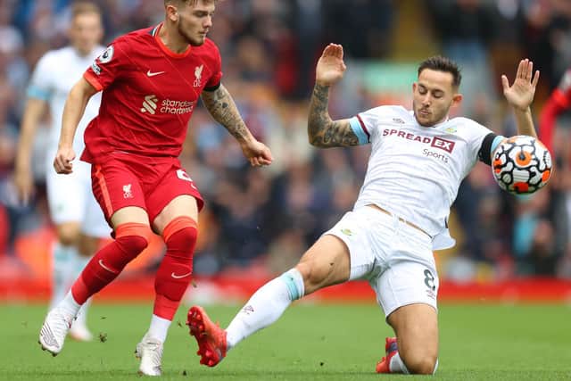 Harvey Elliott of Liverpool is challenged by Josh Brownhill of Burnley during the Premier League match between Liverpool and Burnley at Anfield on August 21, 2021 in Liverpool, England.