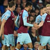Burnley's English defender Ben Mee (R) celebrates with teammates after scoring the opening goal of the English Premier League football match between Everton and Burnley at Goodison Park in Liverpool, north west England on September 13, 2021.