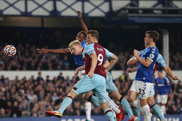 Ben Mee of Burnley scores their team's first goal during the Premier League match between Everton and Burnley at Goodison Park on September 13, 2021 in Liverpool, England.