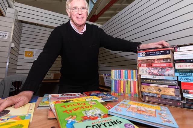 Former Claret Colin Waldron gets ready to welcome customers to the Untidy Bookshelf's second hand book stall in Burnley Market Hall
