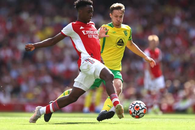 Albert Sambi Lokonga of Arsenal makes a pass whilst under pressure from Kieran Dowell of Norwich City during the Premier League match between Arsenal and Norwich City at Emirates Stadium on September 11, 2021 in London, England.
