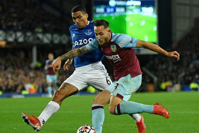 Everton's Brazilian midfielder Allan (L) vies with Burnley's English midfielder Josh Brownhill (R) during the English Premier League football match between Everton and Burnley at Goodison Park in Liverpool, north west England on September 13, 2021.