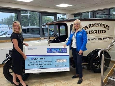 Louisa Mayor, sales and new product development manager at Farmhouse Biscuits (left) hands over the cheque to ELHT and Me fundraising manager, Denise Gee