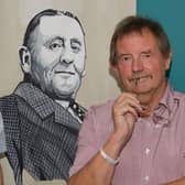 Dave Thomas next to an image of former Burnley FC chairman Bob Lord who was one of the few people to recognise the contribution player Jimmy Hogan made to the sporting world.