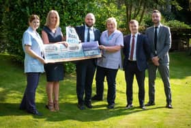 Aaron Tunbridge, Reece Farrar and Greg Forbes from Petty's  hand over the cheque to Helen McVey and nursing staff at Pendleside Hospice
