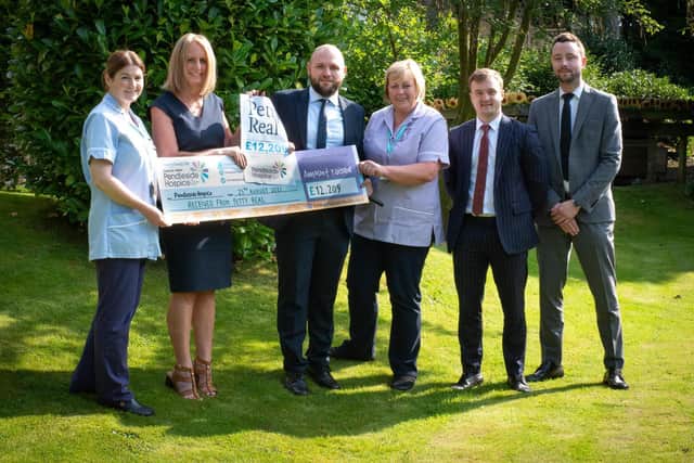 Aaron Tunbridge, Reece Farrar and Greg Forbes from Petty's  hand over the cheque to Helen McVey and nursing staff at Pendleside Hospice
