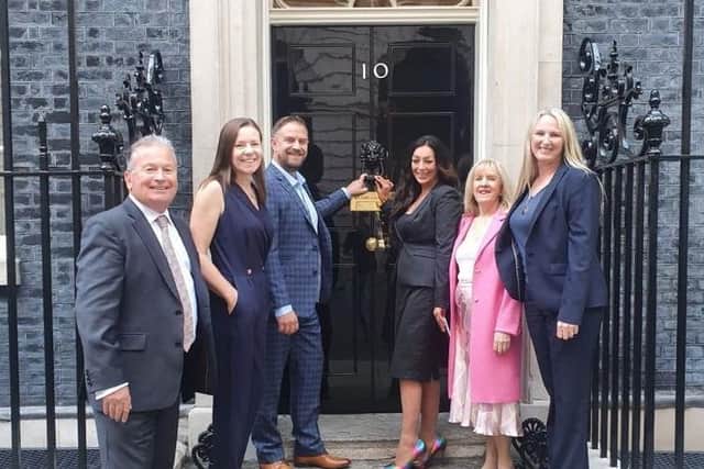 Andy (back left) with homelessness campaigner Amy Varle (back right) with other representatives at Downing Street