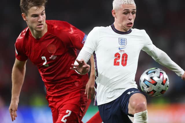 Phil Foden of England is challenged by Joachim Andersen of Denmark during the UEFA Euro 2020 Championship Semi-final match between England and Denmark at Wembley Stadium on July 07, 2021 in London, England.