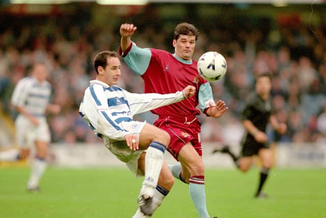 Matthew Rose of Queens Park Rangers clears from Andy Payton of Burnley during the Nationwide League Division One match played at Loftus Road, in London. Burnley won the match 1-0.