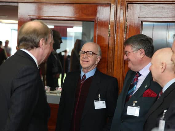 On a royal visit to Turf Moor in 2010, Prince Charles talks to Jim Thompson who had worked at the football club for 63 years