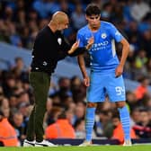 Pep Guardiola gives instructions to Manchester City defender Finley Burns against Wycombe