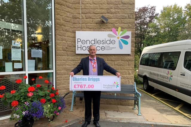 Charlie with a cheque for the money he raised for Pendleside Hospice