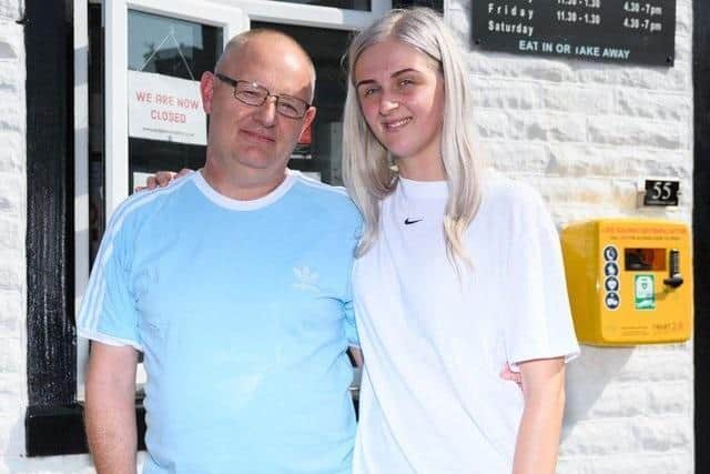 Jodie Sutcliffe with her dad, Michael, whose life she saved when he had a cardiac arrest, with the first defibrillator she raised money for at Rosegrove Chippy in Burnley.